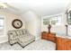 Cozy bedroom featuring patterned sofa and ottoman, neutral walls, and natural light from the window at 19311 Morrison Way, Noblesville, IN 46060