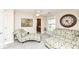 Bright bedroom with patterned seating, a large clock, and an open doorway, creating a welcoming space at 19311 Morrison Way, Noblesville, IN 46060