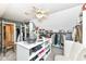 Spacious walk-in closet with white center island, carpet, storage shelves, clothing racks and ceiling fan at 19311 Morrison Way, Noblesville, IN 46060