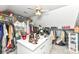Large walk-in closet featuring center island with drawers, shelves, lots of storage, and a ceiling fan at 19311 Morrison Way, Noblesville, IN 46060