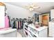 Spacious walk-in closet with white center island, carpet, storage shelves, clothing racks and ceiling fan at 19311 Morrison Way, Noblesville, IN 46060