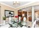 Dining area adjacent to kitchen featuring a glass table and neutral decor at 19311 Morrison Way, Noblesville, IN 46060