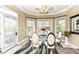 Dining area with a glass-top table, many windows, and neutral decor at 19311 Morrison Way, Noblesville, IN 46060
