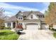 A beautiful home with a three-car garage and a well-maintained lawn, showcasing its inviting curb appeal at 19311 Morrison Way, Noblesville, IN 46060