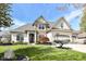 Well-kept lawn and mature landscaping complement the exterior of this attractive single-Gathering home at 19311 Morrison Way, Noblesville, IN 46060