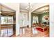Elegant foyer with gleaming hardwood floors, archway, and a chandelier, leading into a sitting room at 19311 Morrison Way, Noblesville, IN 46060
