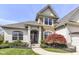Inviting front entrance highlighted by a decorative glass door and lush, manicured landscaping at 19311 Morrison Way, Noblesville, IN 46060