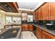 Kitchen showcasing dark backsplash, warm wood cabinets, and granite countertops at 19311 Morrison Way, Noblesville, IN 46060