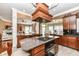 Open kitchen featuring an island with range top and marble countertops at 19311 Morrison Way, Noblesville, IN 46060