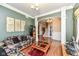 Open concept living area featuring hardwood floors, decorative columns and easy access to staircase at 19311 Morrison Way, Noblesville, IN 46060