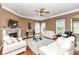 Bright living room with a fireplace, plush rug and multiple windows at 19311 Morrison Way, Noblesville, IN 46060