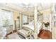 Luxurious primary bedroom with tray ceiling and decorative four poster bed at 19311 Morrison Way, Noblesville, IN 46060