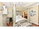 Bedroom featuring tray ceiling, seating, and ensuite bathroom entrance at 19311 Morrison Way, Noblesville, IN 46060