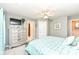 Spacious bedroom showcasing a silver dresser, blue bedding, and ceiling fan, for a comfortable retreat at 19311 Morrison Way, Noblesville, IN 46060