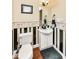 Unique powder room with black and white striped wall and hardwood floors at 19311 Morrison Way, Noblesville, IN 46060