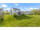 Large grassy backyard featuring a screened-in porch and mature trees at 2020 Tourmaline Dr, Westfield, IN 46074