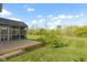 Backyard view showing the screened in porch, deck and lawn at 2020 Tourmaline Dr, Westfield, IN 46074