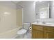 Bathroom with a shower-tub combo, wood vanity, toilet and mirror at 2020 Tourmaline Dr, Westfield, IN 46074