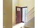 Bright entryway featuring hardwood floors, a staircase, and a stylish front door at 2020 Tourmaline Dr, Westfield, IN 46074