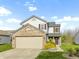 Charming two-story home with brick details, attached garage, and landscaped front yard at 2020 Tourmaline Dr, Westfield, IN 46074