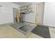 Utility access in garage with overhead shelving, water softener, and door to interior at 2020 Tourmaline Dr, Westfield, IN 46074