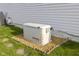 Residential generator with brick trim on a grassy lawn at 2020 Tourmaline Dr, Westfield, IN 46074