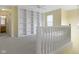 Open floor plan with a large built-in bookcase, neutral carpet and paint, and a ceiling fan at 2020 Tourmaline Dr, Westfield, IN 46074