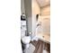 Clean bathroom with a walk-in shower, toilet, and vanity, complemented by wood-look flooring at 2022 Indiana Ave, Columbus, IN 47201