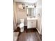 Neutral toned bathroom with toilet, vanity sink and mirror at 2022 Indiana Ave, Columbus, IN 47201