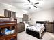 Spacious bedroom with a bunk bed, full size bed, ceiling fan, and neutral carpet at 2022 Indiana Ave, Columbus, IN 47201