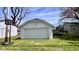 View of a detached garage with basketball hoop and grass at 2022 Indiana Ave, Columbus, IN 47201