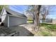 View of a detached garage, grass and trees in the backyard at 2022 Indiana Ave, Columbus, IN 47201