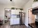 Modern kitchen featuring stainless steel appliances, white cabinets, granite counters, and hardwood floors at 2022 Indiana Ave, Columbus, IN 47201