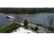 Aerial view capturing the scenic lake, with lush green spaces, and a bridge at 20971 Shoreline Ct # 305, Noblesville, IN 46062