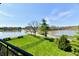 Scenic backyard with lush green lawn and mature trees, overlooking the serene lake view at 20971 Shoreline Ct # 305, Noblesville, IN 46062