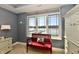 Bedroom with a red bench seat by the window overlooking the lake at 20971 Shoreline Ct # 305, Noblesville, IN 46062