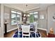 Cozy dining area with modern chandelier, area rug, and scenic outdoor views at 20971 Shoreline Ct # 305, Noblesville, IN 46062