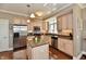 Spacious kitchen with stainless steel appliances, an island with a granite countertop, and wooden floors at 20971 Shoreline Ct # 305, Noblesville, IN 46062