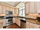 Bright kitchen with stainless steel appliances, granite countertops, and wooden floors at 20971 Shoreline Ct # 305, Noblesville, IN 46062