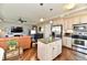 Open-concept kitchen and living room with stainless steel appliances and wood floors at 20971 Shoreline Ct # 305, Noblesville, IN 46062