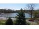 Scenic lake view surrounded by lush greenery, trees, and roadway nearby at 20971 Shoreline Ct # 305, Noblesville, IN 46062