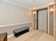 Hallway view of condo featuring bench and elevator, neutral paint, and tiled walls at 20971 Shoreline Ct # 305, Noblesville, IN 46062