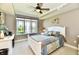 Cozy bedroom featuring a ceiling fan, a full bed, and a large window providing natural light at 20971 Shoreline Ct # 305, Noblesville, IN 46062