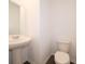 Cozy half-bathroom with pedestal sink and toilet, complemented by modern flooring at 210 Aster Way, Greenfield, IN 46140