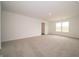 A spacious bedroom with neutral carpet, white walls, and a large window that fills the space with natural light at 210 Aster Way, Greenfield, IN 46140