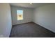 Compact, empty bedroom with neutral carpet, a bright window offering natural light, and clean, white walls at 210 Aster Way, Greenfield, IN 46140