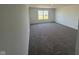 Neutral-toned carpeted bedroom featuring a bright window that gives the room an airy atmosphere at 210 Aster Way, Greenfield, IN 46140
