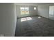 Empty bedroom with neutral carpet, window letting in natural light, and a doorway leading to another room at 210 Aster Way, Greenfield, IN 46140