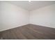 A minimalist bedroom with sleek, dark-toned floors, white walls, and ample natural light at 210 Aster Way, Greenfield, IN 46140