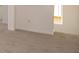 Neutral bedroom features neutral carpet, white walls, and a trim window for natural light and a calming aesthetic at 210 Aster Way, Greenfield, IN 46140